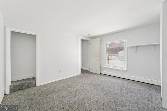 unfurnished bedroom featuring carpet and baseboards