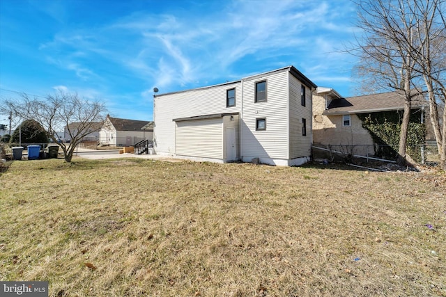 back of property featuring a lawn and fence