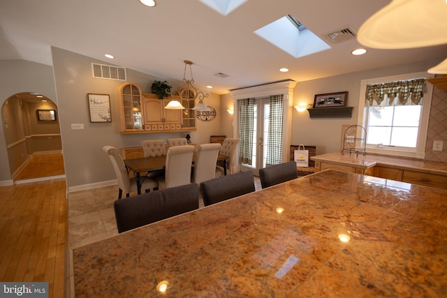 unfurnished dining area with vaulted ceiling