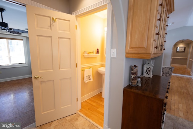 hall featuring light hardwood / wood-style flooring and wood walls