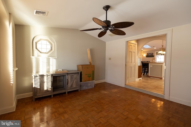 interior space featuring ceiling fan, parquet flooring, lofted ceiling, and plenty of natural light