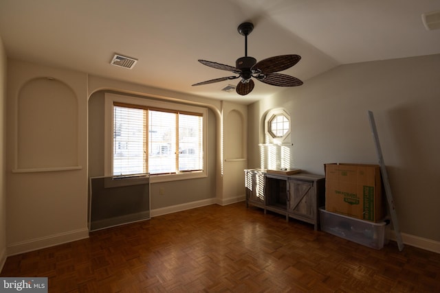 misc room featuring ceiling fan, dark parquet flooring, and vaulted ceiling