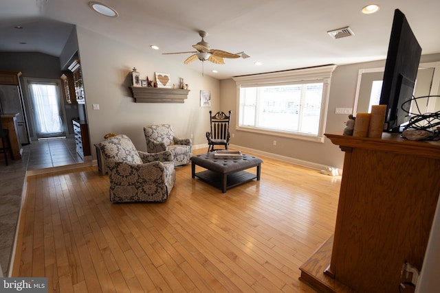 living room featuring ceiling fan and light hardwood / wood-style flooring