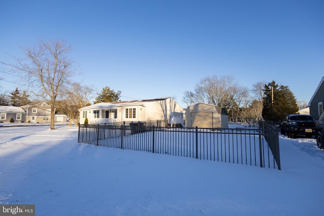 view of snow covered rear of property