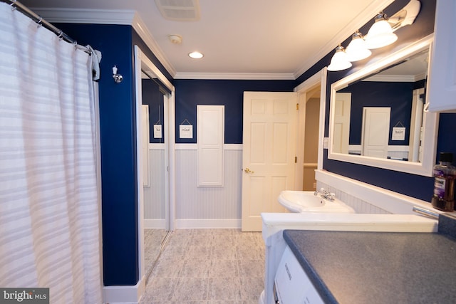 bathroom with sink and ornamental molding