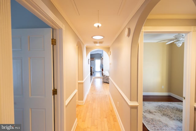 corridor with crown molding and light wood-type flooring