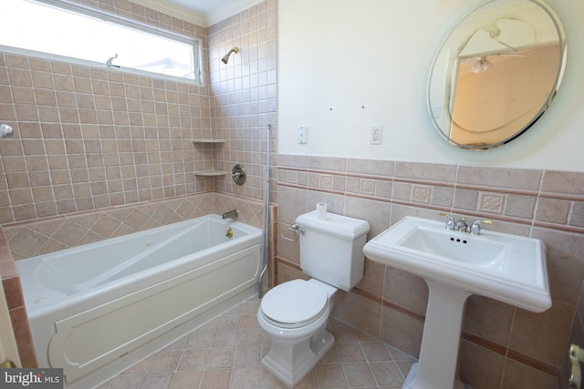 bathroom featuring tile walls, tiled shower / bath, tile patterned flooring, and toilet