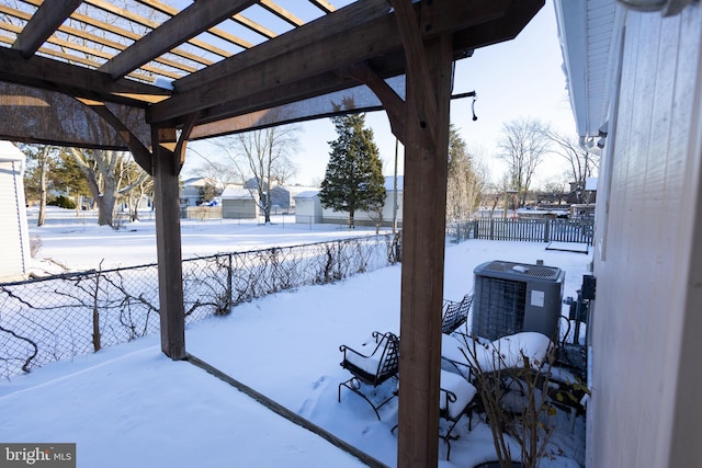 yard covered in snow featuring cooling unit and a pergola