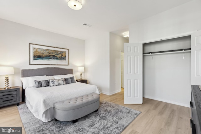 bedroom with a closet and light hardwood / wood-style flooring