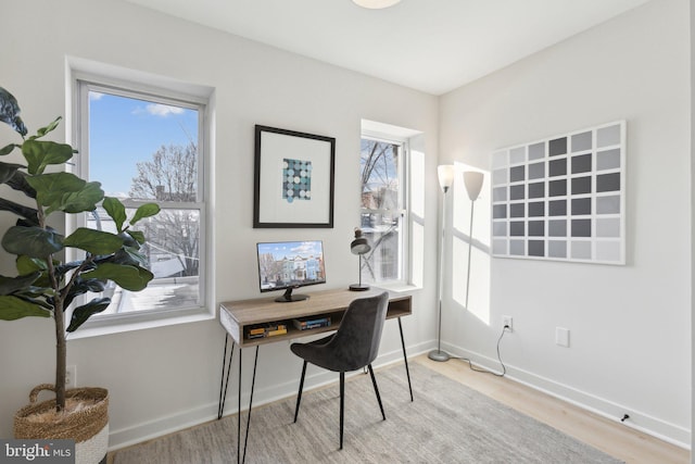 office with a healthy amount of sunlight and light wood-type flooring