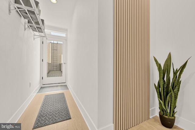 hallway with recessed lighting, wood finished floors, and baseboards