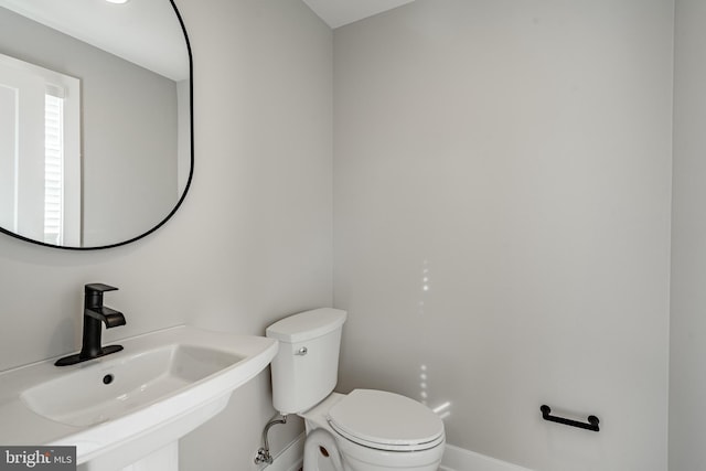 bathroom with toilet and sink