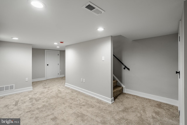 basement featuring light carpet