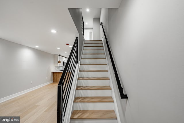 stairway featuring hardwood / wood-style floors