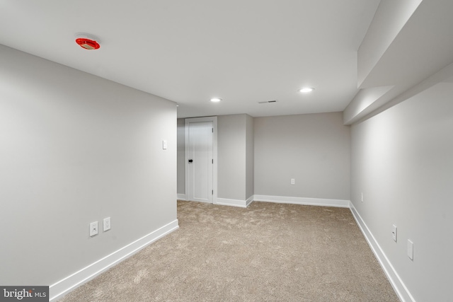 basement featuring light carpet