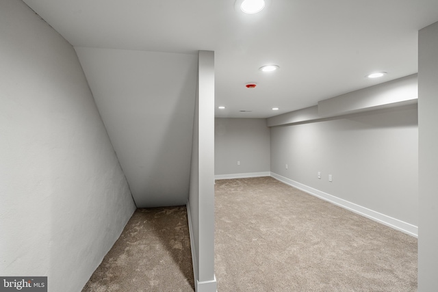 basement featuring light colored carpet