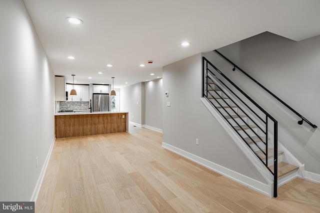 unfurnished living room featuring light wood-type flooring