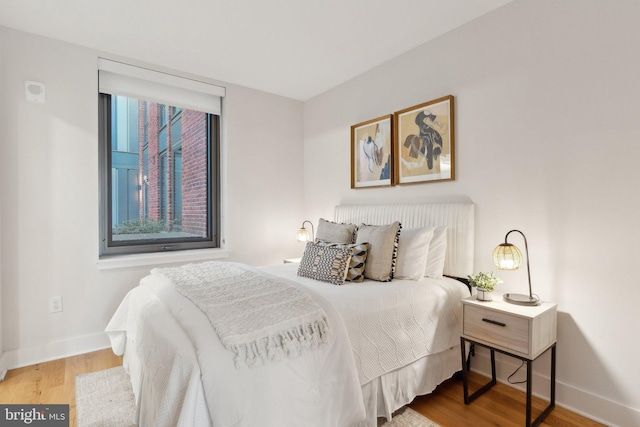 bedroom with hardwood / wood-style floors