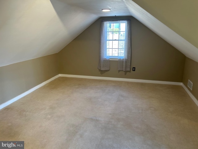 bonus room featuring visible vents, baseboards, carpet, and vaulted ceiling