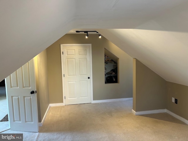 bonus room featuring carpet, baseboards, and vaulted ceiling