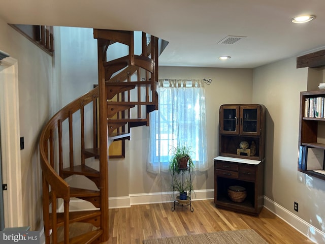 stairs featuring visible vents, recessed lighting, baseboards, and wood finished floors