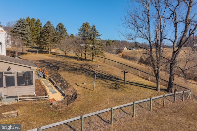 view of yard with a rural view and fence