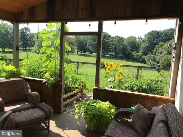 sunroom featuring a wealth of natural light and vaulted ceiling