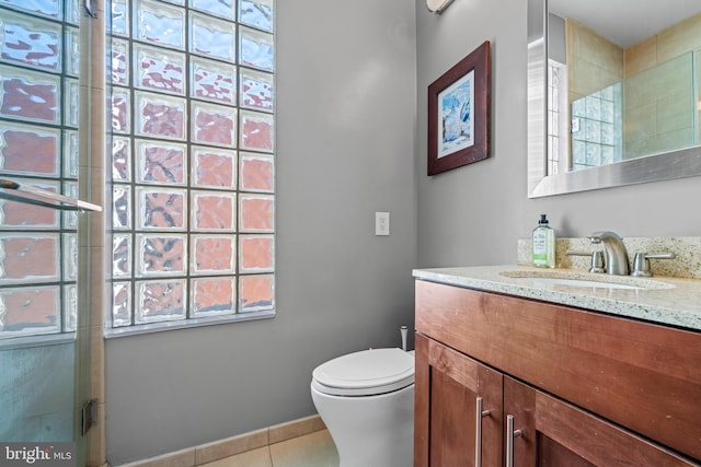 bathroom with tile patterned flooring, an enclosed shower, vanity, and toilet