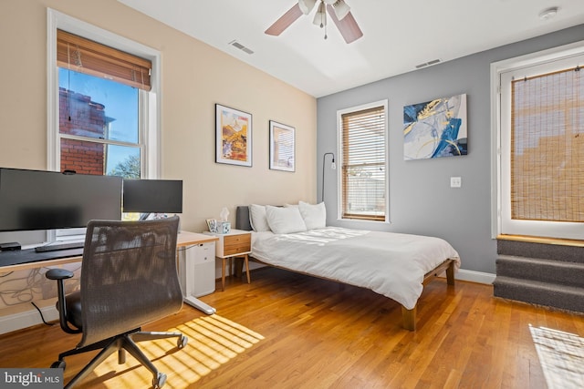 bedroom with ceiling fan and light hardwood / wood-style floors