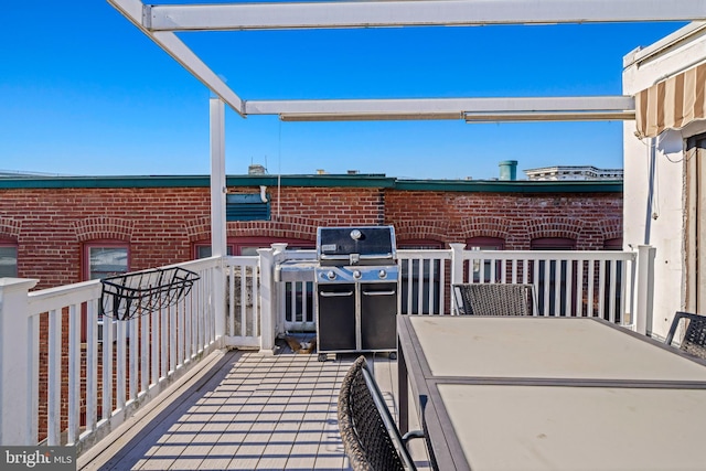 view of patio / terrace with a grill, a pergola, and a balcony