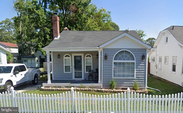 bungalow-style home with a porch and a front yard