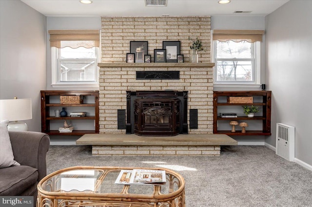 living room featuring a brick fireplace and carpet flooring