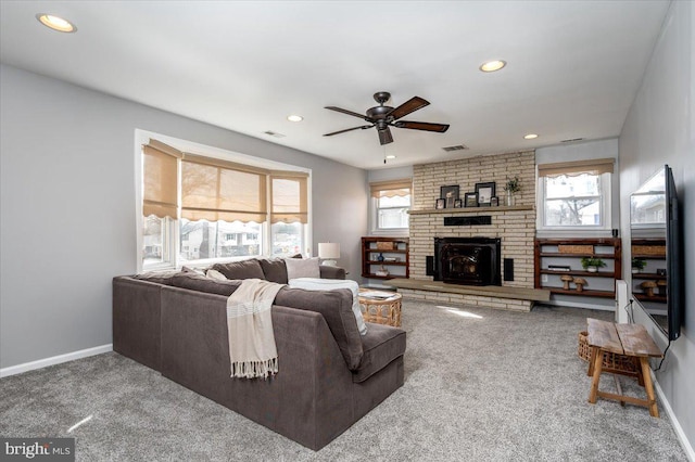 carpeted living room featuring ceiling fan and a healthy amount of sunlight