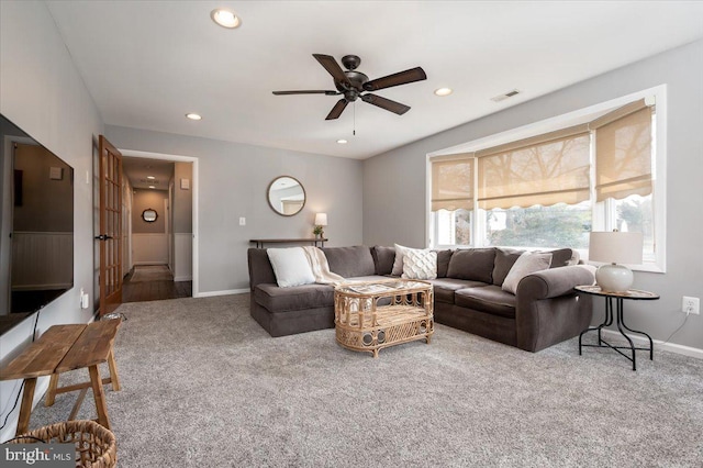 living room featuring ceiling fan and carpet