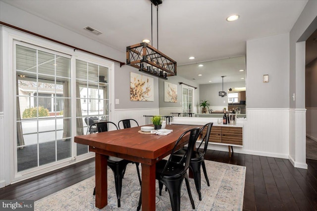 dining space featuring dark wood-type flooring