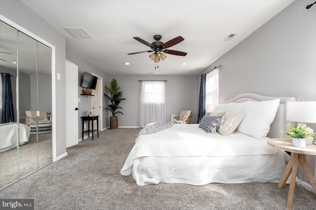 carpeted bedroom featuring a closet and ceiling fan