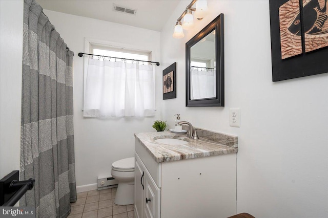 bathroom with a baseboard radiator, toilet, vanity, and tile patterned floors