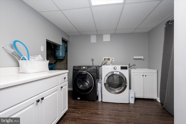 clothes washing area featuring sink, washer and dryer, cabinets, and dark wood-type flooring