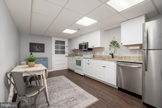 kitchen featuring sink, appliances with stainless steel finishes, white cabinets, and dark hardwood / wood-style flooring