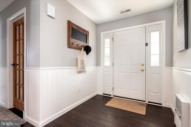 entryway with radiator heating unit and dark hardwood / wood-style floors