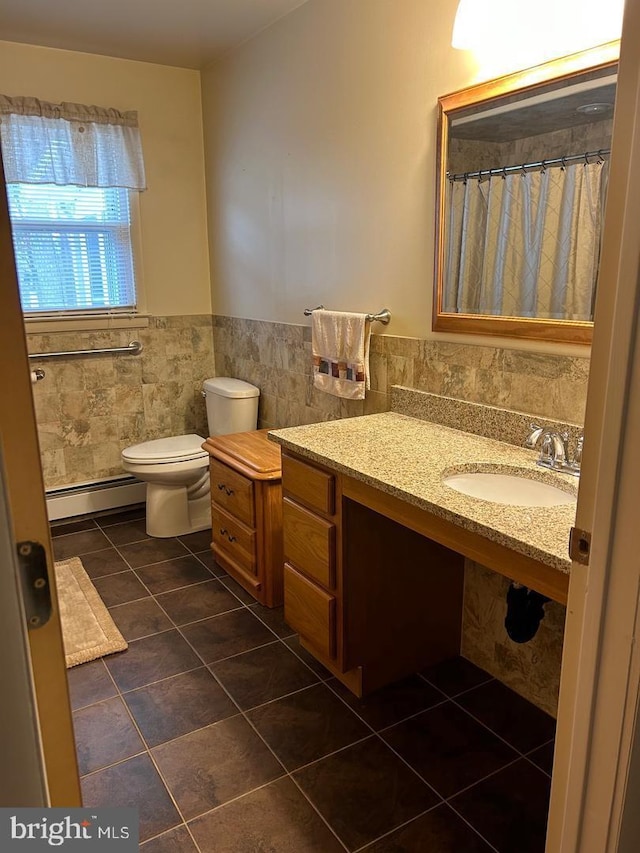 bathroom with sink, tile walls, tile patterned flooring, a baseboard radiator, and toilet