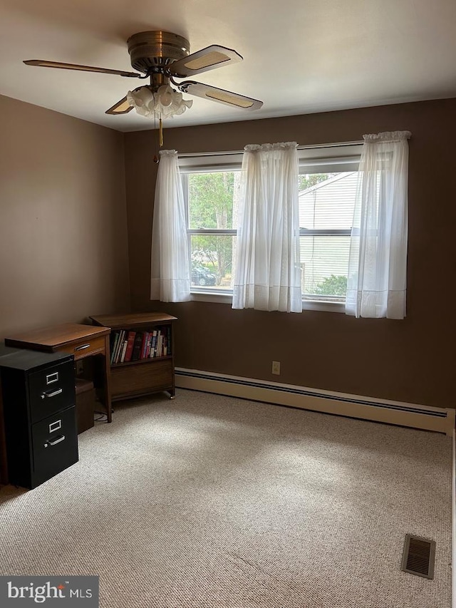 spare room featuring carpet, ceiling fan, and baseboard heating