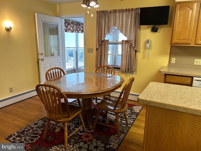 dining room with baseboard heating and light hardwood / wood-style floors