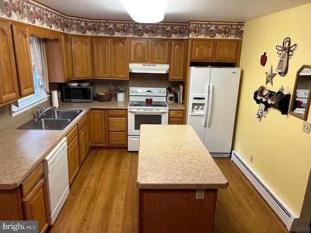 kitchen featuring a baseboard heating unit, sink, white appliances, and light wood-type flooring