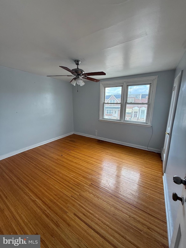 empty room with light hardwood / wood-style flooring and ceiling fan