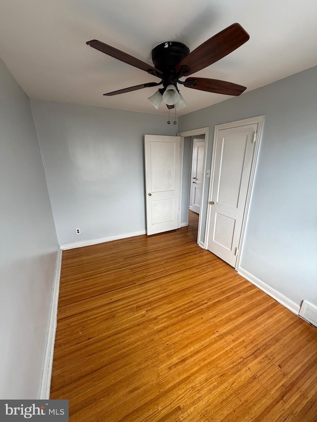 unfurnished bedroom featuring light hardwood / wood-style flooring and ceiling fan