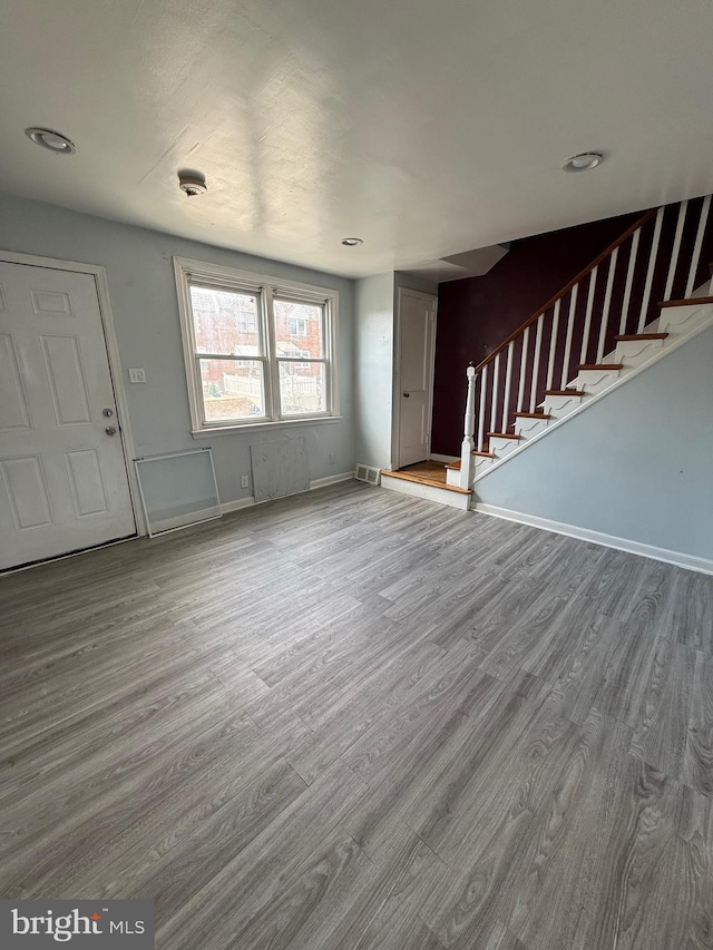 unfurnished living room with hardwood / wood-style floors