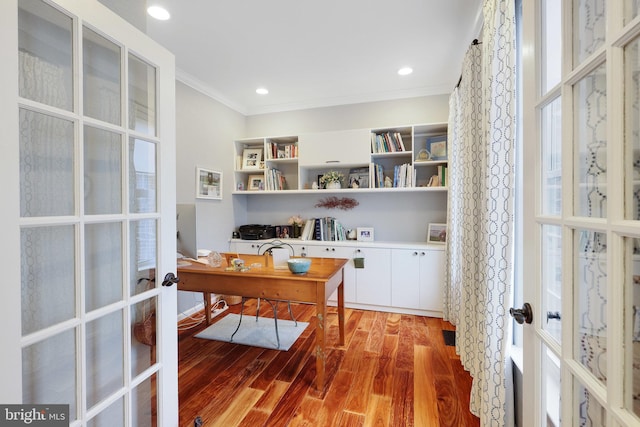 office with french doors, crown molding, and hardwood / wood-style floors