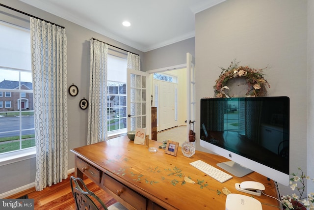 office space with crown molding, light hardwood / wood-style floors, and a healthy amount of sunlight