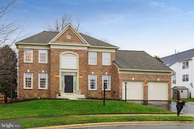 view of front of house featuring a garage and a front lawn